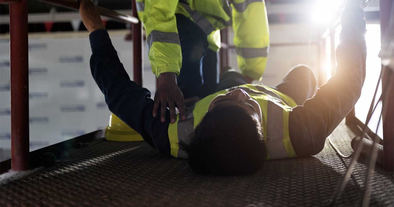 work accident victim lying on floor 